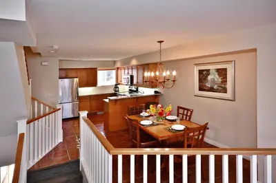 a kitchen and dining room with a table and a dining room at Villas at Eldorado Resort in Kelowna