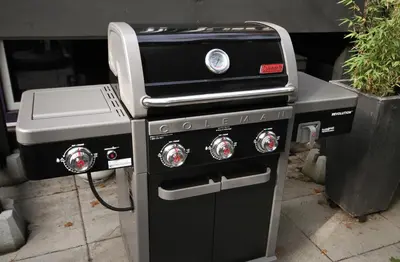 a stove and a grill with a grill at The Orange Door Bungalow- 2-BR w private yard, walkable to cafes & restaurants, 10 min to DT in Vancouver