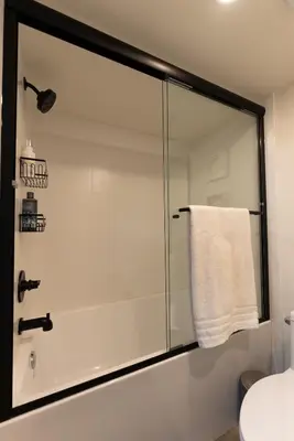 a shower with a glass door in a bathroom at Guest Suite steps away from parks, trails & transit. in Port Coquitlam