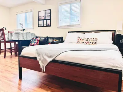 a large bed in a room with a table at Cozy 2 beds Spacious rooms,Close to transit in Vancouver