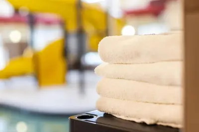a stack of folded towels sitting on a table at Home Inn and Suites Lloydminster in Lloydminster