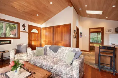a living room with a couch and a table at Caboose in Bowen Island
