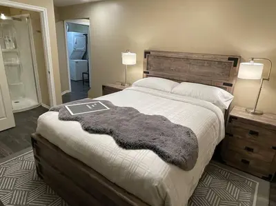 a bedroom with a bed with a furry blanket on it at Cozy Furnished Apartment in Simpson