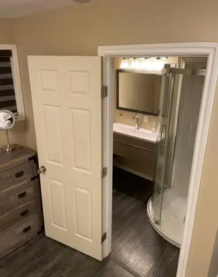 a bathroom with a sink and a shower and a mirror at Cozy Furnished Apartment in Simpson