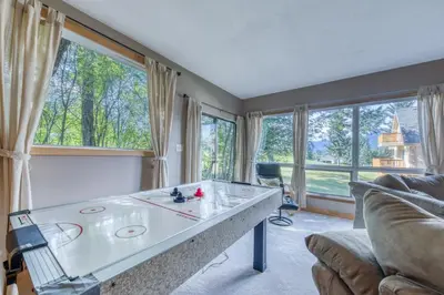 a living room with a ping pong table at Fairmont Hot Springs, 3 Bedroom Vacation Home in Fairmont Hot Springs