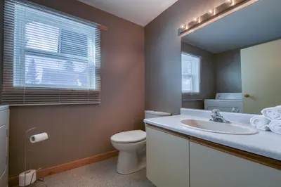 a bathroom with a sink and a toilet and a mirror at Fairmont Hot Springs, 3 Bedroom Vacation Home in Fairmont Hot Springs