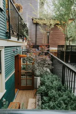 a wooden deck with a wooden door on a house at A Gentle Hideaway in the Urban Forest WEST END downtown Vancouver in Vancouver