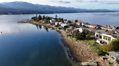 an island in the middle of a large body of water at The Beach House at Deep Bay in Bowser
