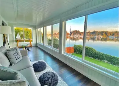 a living room with a large window view of the water at The Beach House at Deep Bay in Bowser