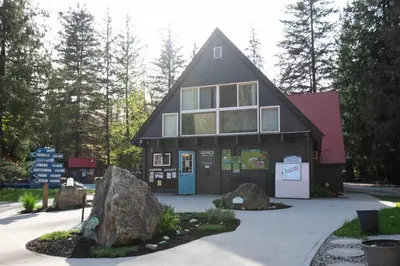 a large building with a blue door and some rocks at Revelstoke RV & Cabin Resort in Revelstoke