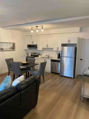 a kitchen with a couch and a table and a refrigerator at Adorable 1 Bedroom Suite- a skip to Galloping Goose in Victoria