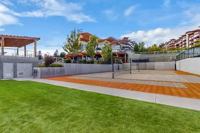 a tennis court in the backyard of a house at Luxury Getaway at Copper Sky 104 in West Kelowna
