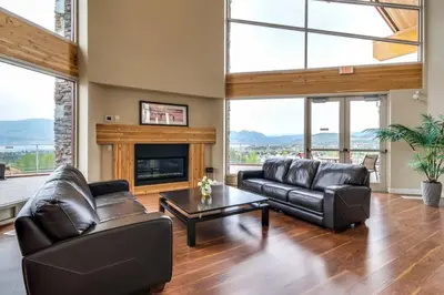 a living room with leather furniture and a fireplace at Luxury Getaway at Copper Sky 104 in West Kelowna