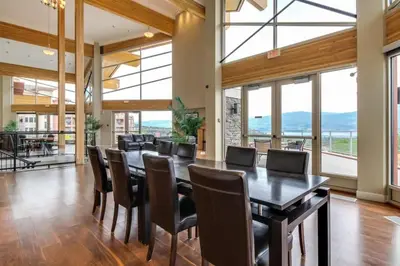 a dining room with a long table and chairs at Luxury Getaway at Copper Sky 104 in West Kelowna