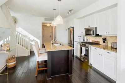 a kitchen with white cabinets and a counter top at The Beach House at Barona Beach 4301 in West Kelowna
