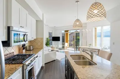 a kitchen with a sink and a stove top oven at The Beach House at Barona Beach 4301 in West Kelowna