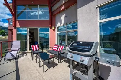 a grill on the patio of a house at Top Floor Apartment at Amenity Rich Resort 406 in West Kelowna