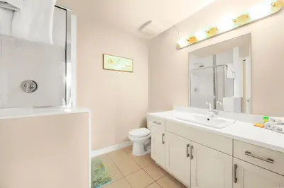 a white bathroom with a sink and a toilet at Top Floor Apartment at Amenity Rich Resort 406 in West Kelowna