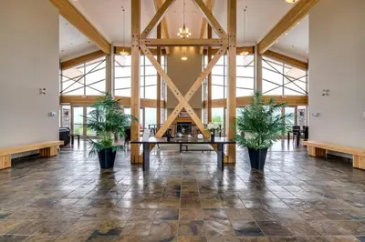 a large lobby with a table and two potted plants at Fabulous Condo at Five Star Resort 209 in West Kelowna
