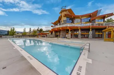 a large swimming pool in front of a building at Fabulous Condo at Five Star Resort 209 in West Kelowna