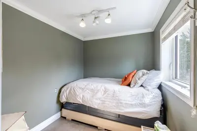 a small bedroom with a bed with a window at Yukon River Farm in Whitehorse
