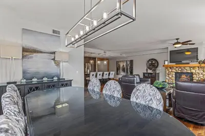 a dining room with a glass table and chairs at 3 Bedroom Condo by Canadian Rockies Vacation Rentals in Canmore