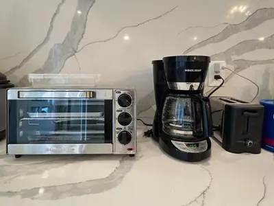 a toaster oven and a coffee maker on a counter at Shambhala Zen Suite in Nanoose Bay