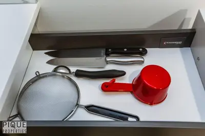 a box with a pair of scissors and other kitchen utensils at *NEW* Modern Suite King Bed! Netflix! Sleeps 4! in Edmonton