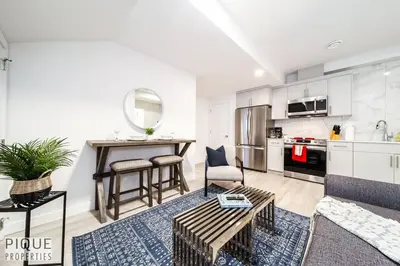 a living room with a couch and a table at *NEW* Modern Suite King Bed! Netflix! Sleeps 4! in Edmonton