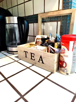 a box of tea sitting on a kitchen counter at Cozy 3 Bedroom Contemporary Home With Free Parking in Edmonton