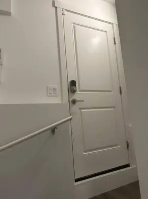 a white door in a room with a wall at Brand new 1 Bedroom Basement Suite. Wi-Fi,Netflix in Edmonton