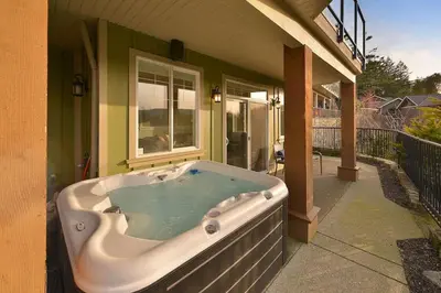 a hot tub on the side of a house at Mount Finlayson View Villa by EMR Vacation Rentals in Victoria