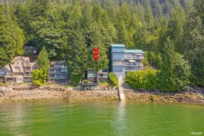 a group of houses on the shore of a river at SALT COTTAGE Waterfront Guest House with Superb Views in West Vancouver