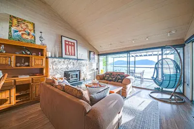 a living room with two couches and a fireplace at SALT COTTAGE Waterfront Guest House with Superb Views in West Vancouver