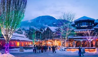 a group of people walking around a town with christmas lights at SALT COTTAGE Waterfront Guest House with Superb Views in West Vancouver