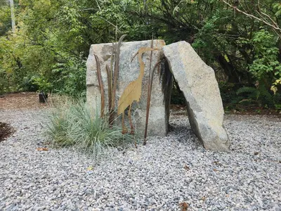 a statue of a rock with some plants on it at The Shed at Moon Dance in Madeira Park