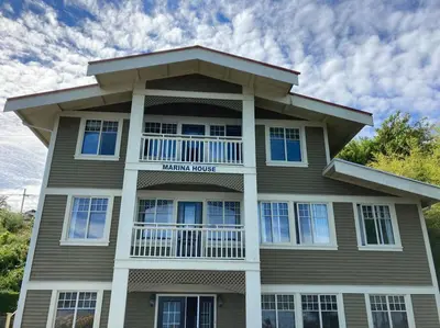 a large house with a balcony on top of it at Iconic 3-Story Waterfront 'Marina House' w/ View in Gibsons