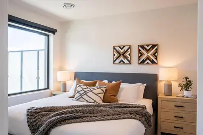 a bedroom with a bed and a window at The Big Deck by Revelstoke Vacations in Revelstoke