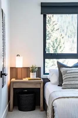 a bedroom with a bed and a desk with a window at The Big Deck by Revelstoke Vacations in Revelstoke