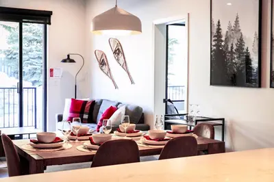a dining room with a table and chairs at Monashee Sunshine - Condo with Private Hot Tub in Revelstoke