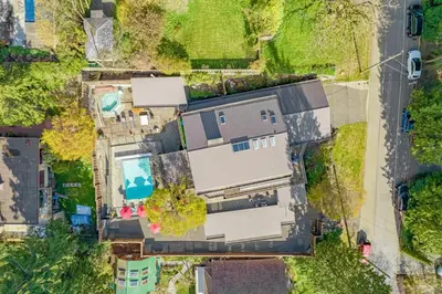 an overhead view of a house with a yard at Grouse Cheerful large private bedroom, bath, shared deck, pool, hot tub in North Vancouver