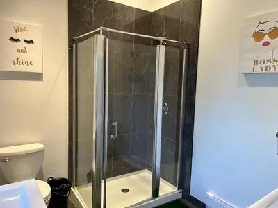 a shower stall in a bathroom with a toilet at Grouse Cheerful large private bedroom, bath, shared deck, pool, hot tub in North Vancouver
