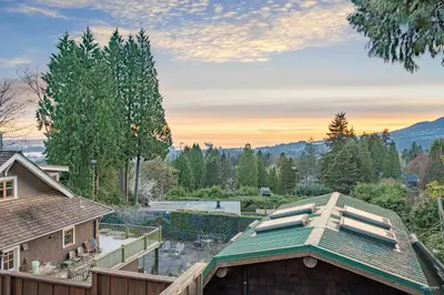 an aerial view of a house with a roof at Grouse Cheerful large private bedroom, bath, shared deck, pool, hot tub in North Vancouver