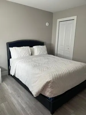 a bedroom with a large bed with white sheets at Dugg Bed And Breakfast in Victoria