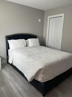 a bedroom with a large bed with white sheets at Dugg Bed And Breakfast in Victoria