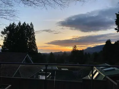 a sunset from the balcony of a house at Cypress: Private Bedroom/Bathroom/Office, with Shared Pool, Hot tub in North Vancouver