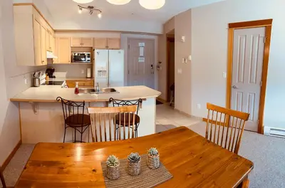 a kitchen and dining room with a wooden table at Wanna get away in the Rocky Mountains in Canmore