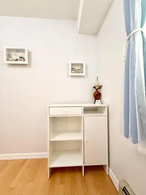 a white cabinet in a room with a wall at Burnaby Metrotown Cozy 3 Bedroom Suite Walk to Skytrain and Malls in Burnaby