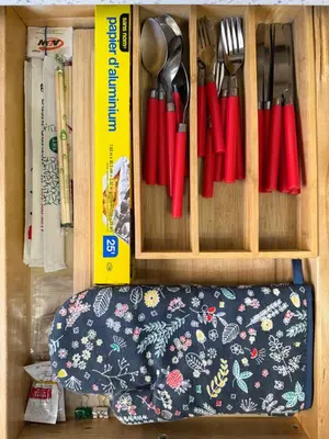 a cupboard with utensils in it with a cushion sidx sidx sidx sidx at Burnaby Metrotown Cozy 3 Bedroom Suite Walk to Skytrain and Malls in Burnaby