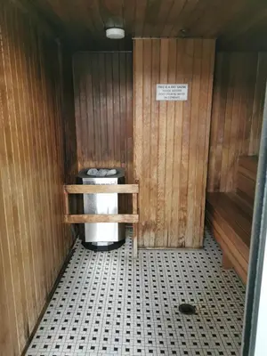 a bathroom with a toilet in a wooden room at GardenView Modern Condo with Parking, Gym, Pool, AC in Vancouver
